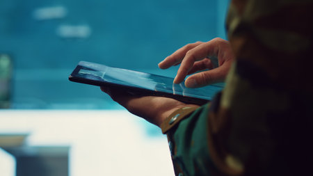 Army officer examines reconnaissance system on a world map, targeting enemy aircraft or warships on the national territory. Military personnel tracks status of deployed units. Close up. Camera A.の写真素材