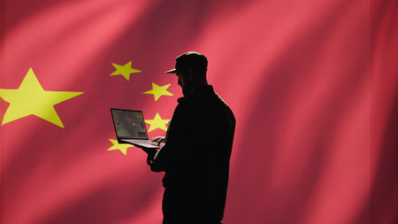 Chinese air defense operator using radar system on laptop to detect intercontinental ballistic missiles. CCP red army soldier scanning rockets approaching borders, isolated over China flag, camera Bの写真素材
