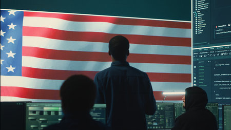Cyber defense experts in a governmental tech room with the American flag. Working on secure computing, digital forensics and cyber operations to protect and maintain cyber safety. Camera A.の写真素材