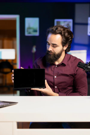 Media star in studio filming tech tutorial on how to do maintenance on broken tablet. Technology online show host teaching subscribers how to open and fix damaged digital deviceの写真素材
