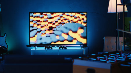 Close up shot of 3D rendered animations running on TV screen in empty house with warm lighting. Living room apartment illuminated by neon lights and decorated with stylish modern home decorの写真素材