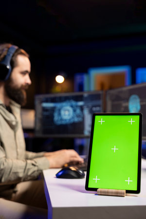 Focus on chroma key tablet with sentient AI in blurry background gaining humanoid form. Isolated...