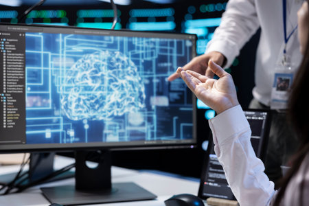 Technicians working in data center with artificial intelligence technology to process massive datasets, close up. IT specialists in server hub facility storing data used for machine learningの写真素材