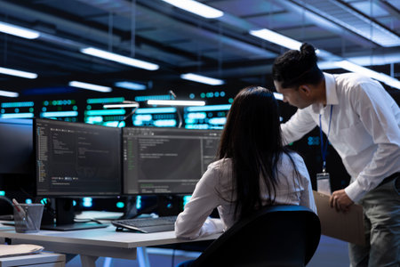 Teamworking technicians in server room looking to find network issues affecting supercomputer...