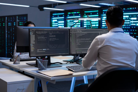 Technician using computer to troubleshoot hardware and software issues in server hub. IT expert...