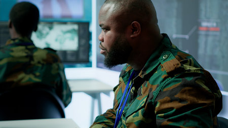 Army professionals in command post overseeing satellite data and real time surveillance, mission intelligence. Support strategic military operations, studying world map and big screen. Camera A.の写真素材
