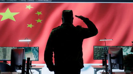 Chinese military officer in uniform monitors critical data on big screen. The national flag is presented in the army operations room, military command center used for propaganda. Camera A.の写真素材