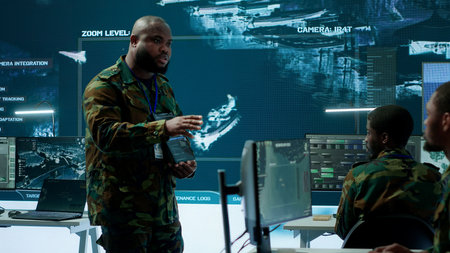 Military officer leads cybersecurity efforts in a high tech control center, ensuring data protection and managing surveillance systems, Coordinating national security operations. Camera A.の写真素材