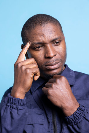 African american protection personnel searches for ways to safeguard the area, thinking about safety measures at the mall. Duty to ensure protection on the premises. Close up.の写真素材