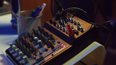 Electronic instruments used for mixing and recording tunes in empty home studio, soundboard controls...
