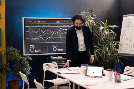 Administrator preparing the boardroom for an important meeting with his staff, discussing latest...