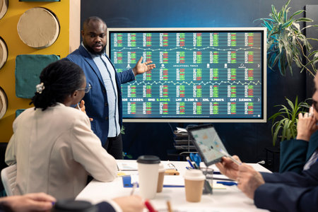 Team leader hosting a meeting in conference room and talking sense into his staff, trying to detect...