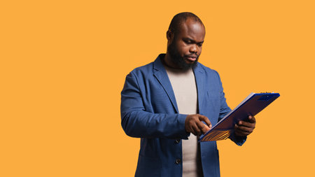 Accountant doing profit analysis for company, browsing files, isolated over studio background. Worker doing financial budgeting and forecasting, complaining about financial figures, camera Bの写真素材