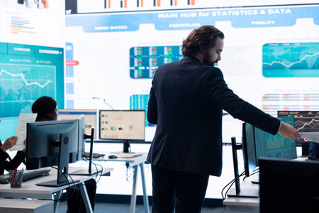 Forecast affiliates working in coworking space office to review latest business news based on performance metrics and progress. Consultants fight to expand the enterprise globally.の写真素材