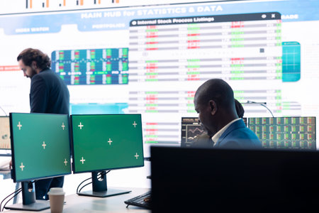 Project manager works with infographics reports and green screen, ensuring business objectives achievement. Male analyst studying the current financial progress, data management.の写真素材