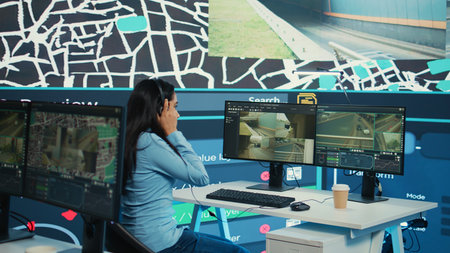 Indian call center operator gives order delivery updates to clients, handling shipment delay complains in control center. Cargo shipping agency directing trucks on less busy routes. Camera B.の写真素材