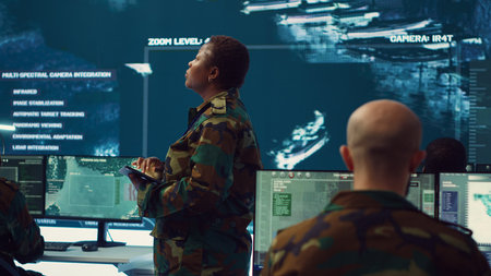 Female brigadier general conducing anti terrorism mission in military operations room, employing radar systems to detect and track enemy aircraft or missiles. Secret service program. Camera A.の写真素材