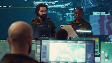 Crew captain and general briefing the troops in military headquarters command center, operating with a big screen to follow CCTV reconnaissance system. Soldiers collecting data. Camera A.の写真素材