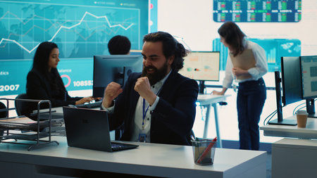 Happy CEO showing his satisfaction and celebrating business success, obtaining more funds to expand...