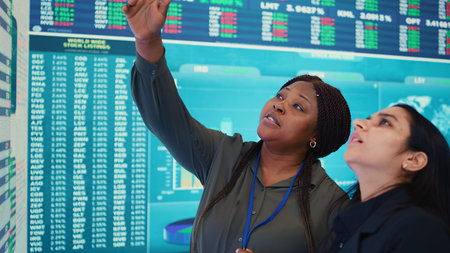 Enterprise colleagues reviewing efficiency and performance metrics within the organization, giving...