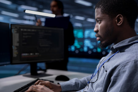 Computer scientist reconfiguring server room to optimize it for data processing requirements of customers. Programmer typing on PC, ensuring data center equipment operates efficiently, close upの写真素材