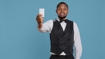Bellhop personnel offering access card to the room for guests, presenting the key after check in...
