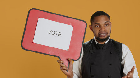 Professional waiter showing a message to vote on speech bubble, creating an advertisement for...