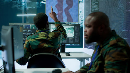 Group of soldiers in a secure office environment collaborates on intelligence analysis, and strategic planning. Crucial efforts for maintaining national security and operational efficiency. Camera A.の写真素材