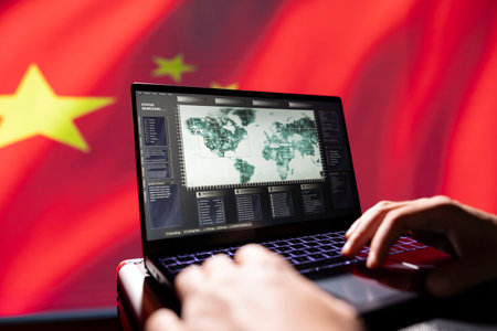 Chinese PSyOp operator using laptop device, making bot accounts attacking Western powers. Close up of IT professional working for China coding troll farm promoting communism doctrine on social mediaの写真素材