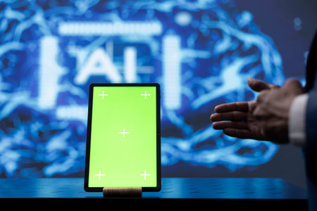 Engineer in startup doing advancements in AI field using mockup tablet. Close up of isolated screen device used by man working in cutting edge workspace featuring artificial intelligenceの写真素材