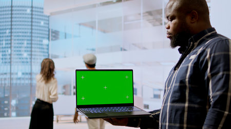 Real estate experts and business owner review blueprints plan next to isolated mockup, working on new high class office design development. Client sharing her modern workspace vision. Camera A.の写真素材