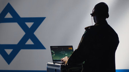 Israeli air defense command operator conscript using radar system on laptop to detect incoming ballistic missiles. IDF army soldier scanning rockets approaching borders, deploying shields, camera Aの写真素材