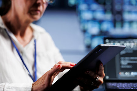 Close up shot of senescent admin writing script code in data center on laptop terminal. Efficient worker doing maintenance work in server room, updating clusters software to prevent malfunctionsの写真素材