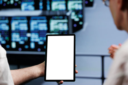 Close up of mock up tablet used by hardworking team in cloud computing business server hub delivering massive computational power, capable of processing and storing vast amounts of datasetsの写真素材