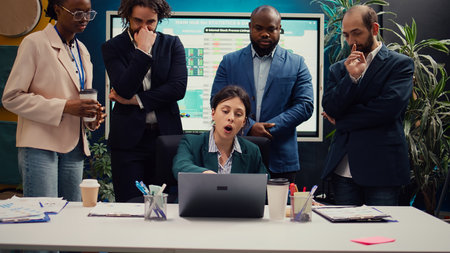 Frustrated angry project manager acting crazy and judging her staff members, reviewing their work and accomplishments. Mad irritated supervisor being displeased with the firm workflow. Camera B.の写真素材