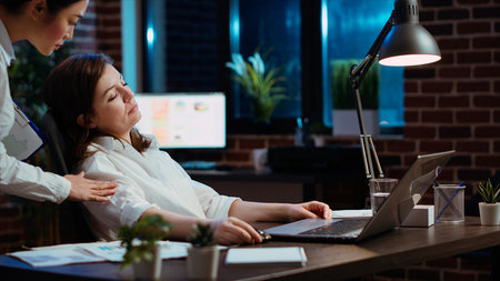 Tired employee sleeping on workspace desk, awaken by manager, excusing herself. Drowsy businesswoman...