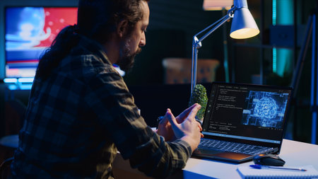 Data scientist updating artificial intelligence neural networks, writing complex binary code scripts. Teleworking freelancer in apartment office uses digital device programming to upgrade AI, camera Aの写真素材