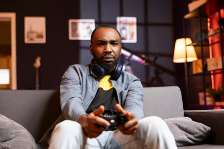 Portrait of irked gamer annoyed after losing in online singleplayer videogame played using...