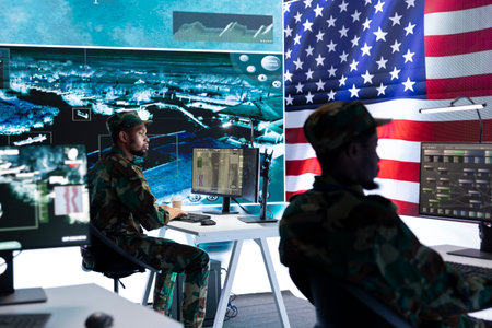 US military officer supervising threat detection activity in high tech office, examining top secret...