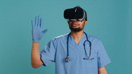 Nurse wearing virtual reality headset remotely operating patient. Healthcare specialist using high tech futuristic modern medical vr gadget, isolated over blue studio background, camera Aの写真素材