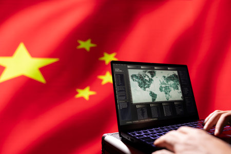 Person using software on laptop in front of Chinese flag.の写真素材