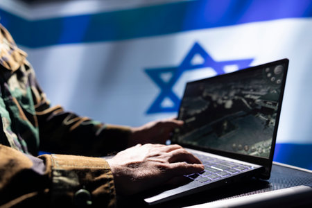 Israeli army operator responsible for Israel air defense, relaying instructions to squadrons patrolling over borders. Close up shot of military expert using laptop software to do monitoringの写真素材
