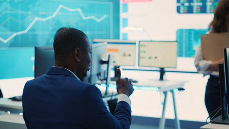 Executive consultant gathers his staff to discuss about performance metrics, looking for ways to improve the workflow in order to achieve business goals and expand on global scale. Camera A.の写真素材