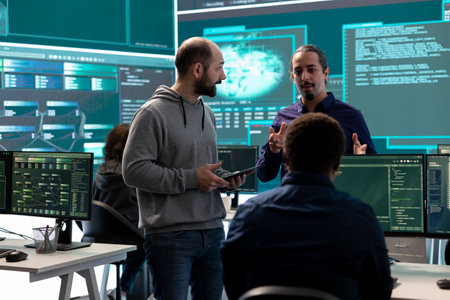 Cyber security team conducting cyber surveillance in a governmental control room. Experts group hacking activities, malware protection and data breach prevention in high tech agency.の写真素材