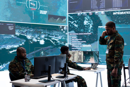 Intelligence experts in a control room managing surveillance operations, analyze real time data and coordinate security measures. Protecting national interests with cctv satellite radar.の写真素材