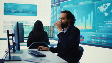 Sales manager reviews financial reports and performance metrics to assess the organizational expansion plans in boardroom. Business consultant examining online infographics. Camera B.の写真素材