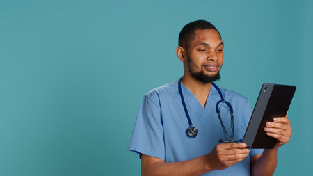 Joyous doctor in videocall meeting using tablet device, providing treatment. Upbeat healthcare...