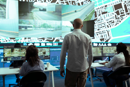 Team leader tracking delivery trucks location around the city, following the satellite map to avoid traffic and ship orders in time. Shipping agency employees updating clients on location.の写真素材