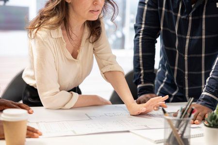 Real estate agents studying the layout of the high class office space building, providing important...