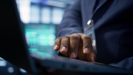 Admin in data center runs system diagnostic tests and error checking utilities on laptop to fix problems. Close up shot of worker looking for network issues affecting rigs performance, camera Bの写真素材